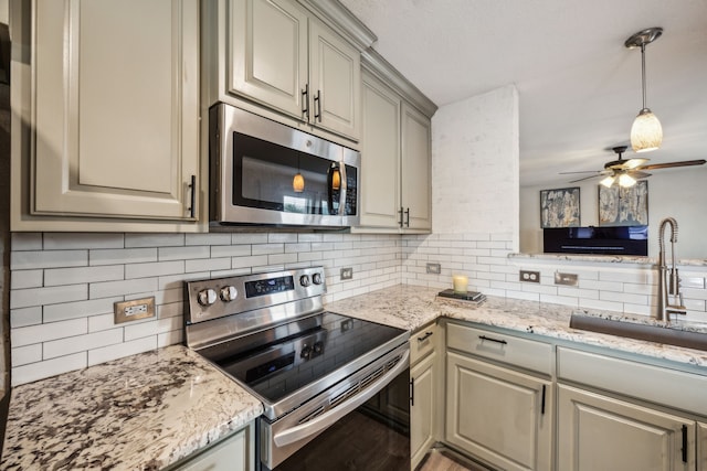 605 Preston Dr, Royse City, TX 75189 - kitchen with stainless steel appliances, a sink, tasteful backsplash, ceiling fan, and light stone counters