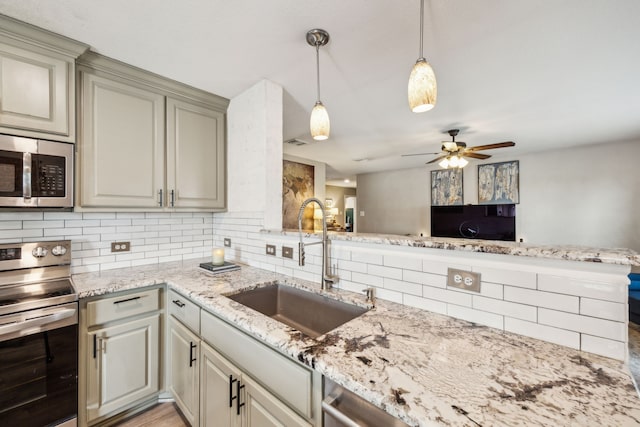 605 Preston Dr, Royse City, TX 75189 - kitchen featuring appliances with stainless steel finishes, a sink, decorative backsplash, ceiling fan, and light stone counters