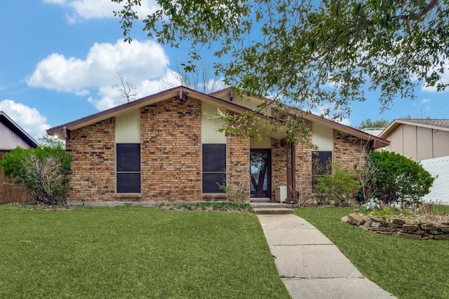 2818 Ashglen Dr, Garland, TX 75043 - mid-century inspired home featuring a front lawn and brick siding