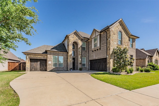1212 Teton Dr, Burleson, TX 76028 - view of front of house featuring concrete driveway, brick siding, stone siding, and a garage