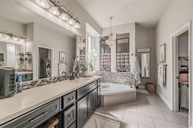 1212 Teton Dr, Burleson, TX 76028 - bathroom with tile patterned floors, vanity, a garden tub, a walk in closet, and baseboards