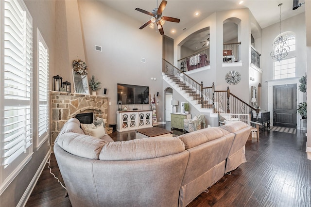 1212 Teton Dr, Burleson, TX 76028 - living room with stairs, ceiling fan, a high ceiling, dark wood-style flooring, and a fireplace