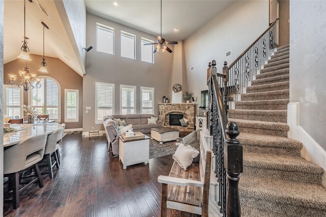 1212 Teton Dr, Burleson, TX 76028 - living room with a ceiling fan, dark wood-style flooring, a fireplace, a chandelier, and stairs
