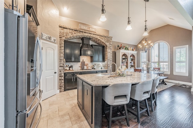 1212 Teton Dr, Burleson, TX 76028 - kitchen with stainless steel appliances, lofted ceiling, a breakfast bar, light stone counters, and a sink