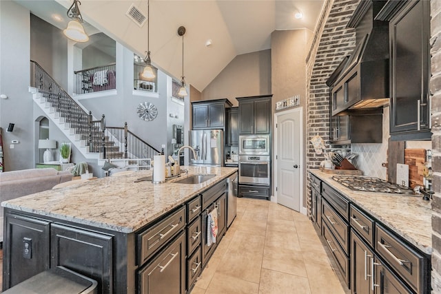 1212 Teton Dr, Burleson, TX 76028 - kitchen featuring a sink, appliances with stainless steel finishes, high vaulted ceiling, decorative light fixtures, and light stone countertops