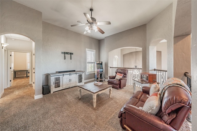 1212 Teton Dr, Burleson, TX 76028 - living room featuring carpet floors, arched walkways, a ceiling fan, a chandelier, and baseboards