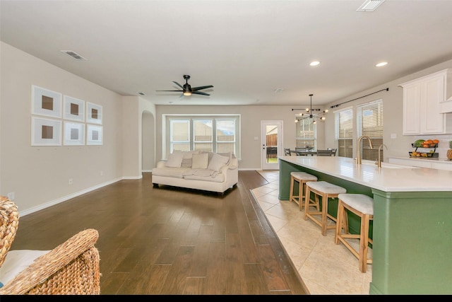 8625 Tribute Ln, Fort Worth, TX 76131 - living room featuring wood finished floors, healthy amount of natural light, a ceiling fan, recessed lighting, and a chandelier