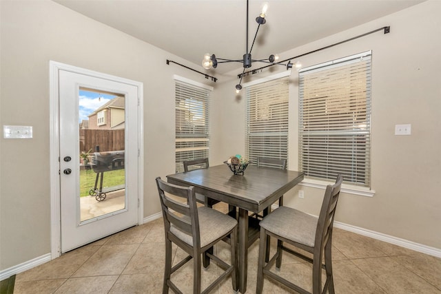 8625 Tribute Ln, Fort Worth, TX 76131 - dining space with a chandelier, light tile patterned flooring, and baseboards