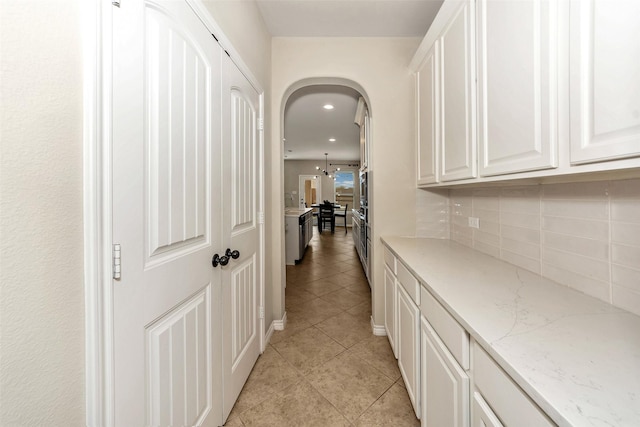 8625 Tribute Ln, Fort Worth, TX 76131 - hall featuring light tile patterned flooring, arched walkways, and recessed lighting