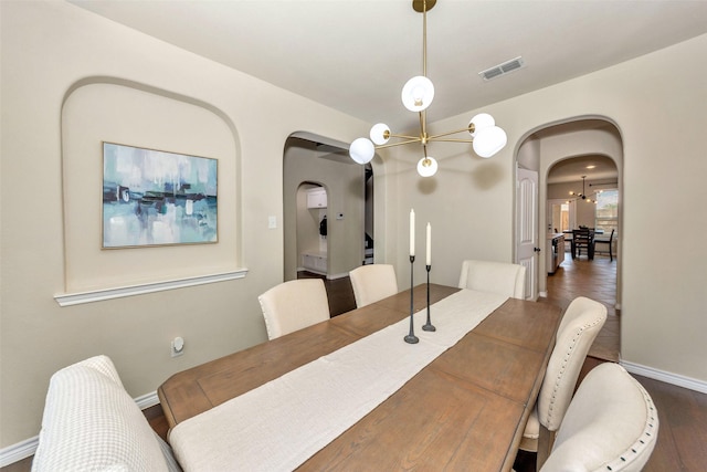 8625 Tribute Ln, Fort Worth, TX 76131 - dining room featuring arched walkways, a chandelier, baseboards, and dark wood-style floors