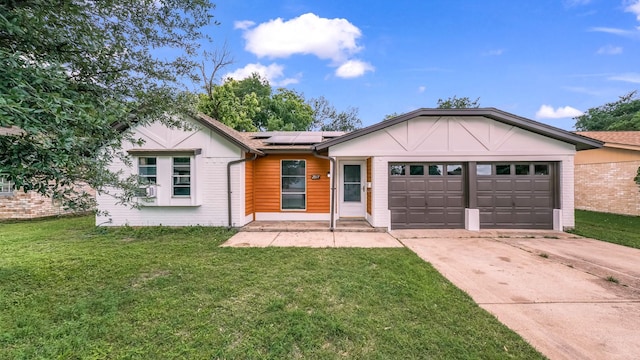 2017 Moline Dr, Haltom City, TX 76117 - single story home featuring concrete driveway, a garage, a front lawn, and roof mounted solar panels
