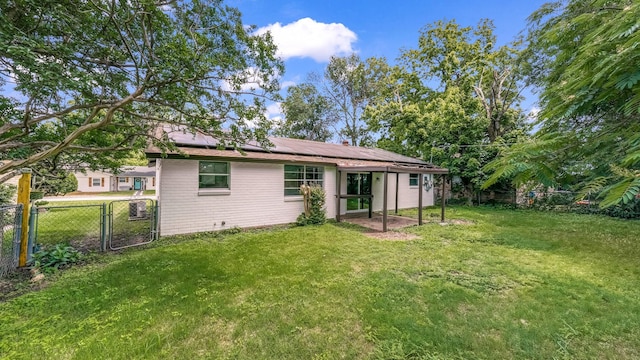 2017 Moline Dr, Haltom City, TX 76117 - back of house with roof mounted solar panels, a gate, and brick siding