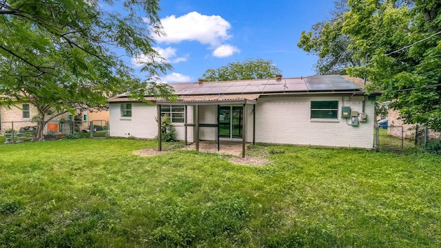 2017 Moline Dr, Haltom City, TX 76117 - rear view of property featuring solar panels and a gate