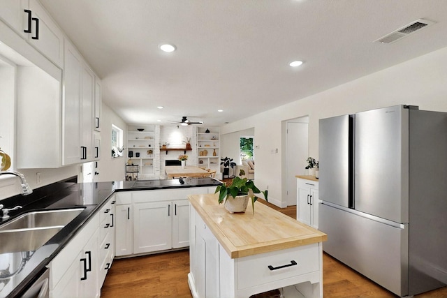 53 Devonshire Dr, Bedford, TX 76021 - kitchen featuring appliances with stainless steel finishes, plenty of natural light, a sink, wooden counters, and recessed lighting