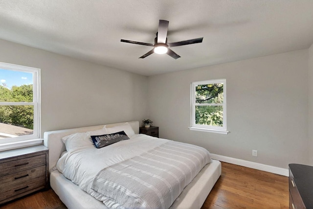 53 Devonshire Dr, Bedford, TX 76021 - bedroom featuring dark wood-type flooring, baseboards, and ceiling fan