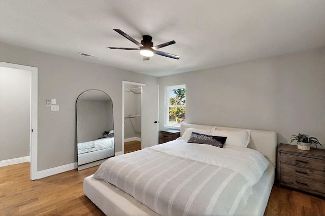 53 Devonshire Dr, Bedford, TX 76021 - bedroom with baseboards, wood finished floors, ceiling fan, a spacious closet, and a closet