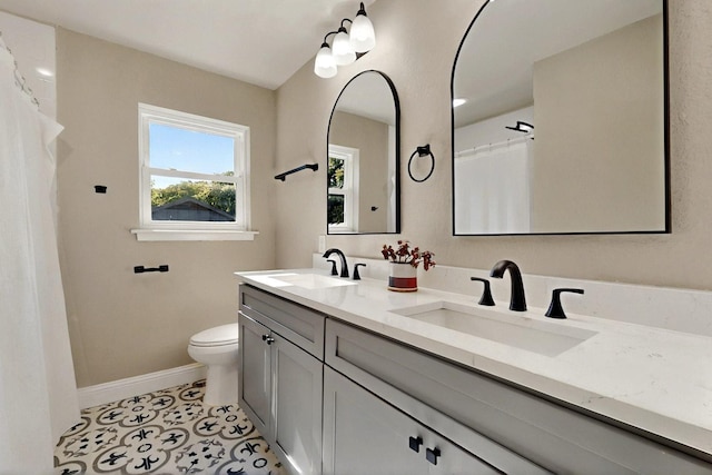 53 Devonshire Dr, Bedford, TX 76021 - full bath with baseboards, toilet, and double vanity
