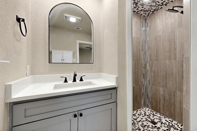 53 Devonshire Dr, Bedford, TX 76021 - full bathroom with vanity, tiled shower, and a textured wall
