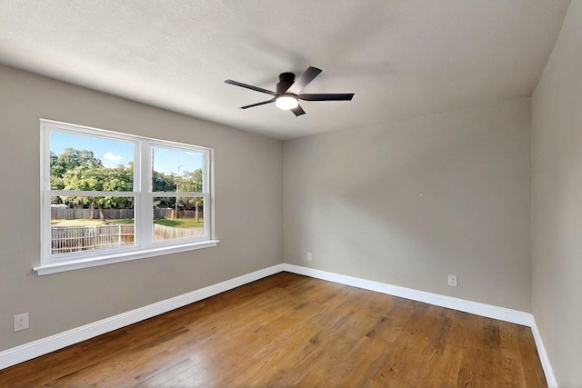 53 Devonshire Dr, Bedford, TX 76021 - spare room with baseboards, wood finished floors, and a ceiling fan