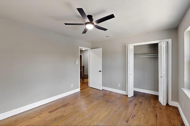 53 Devonshire Dr, Bedford, TX 76021 - unfurnished bedroom with wood finished floors, baseboards, a closet, and a ceiling fan