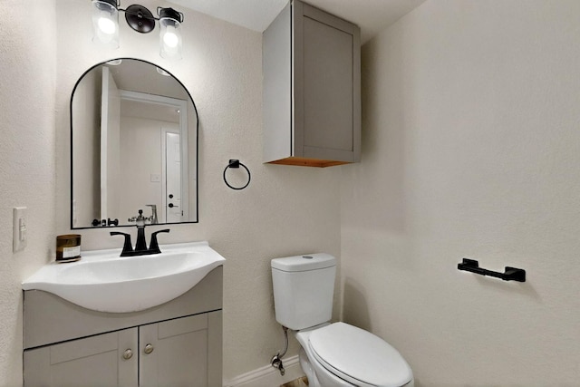 53 Devonshire Dr, Bedford, TX 76021 - half bath with toilet, vanity, and baseboards
