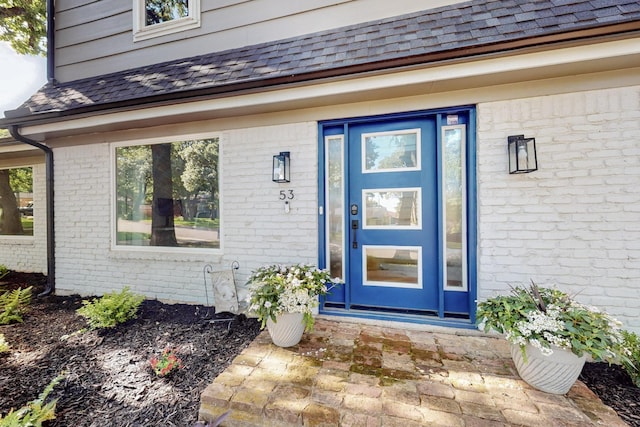 53 Devonshire Dr, Bedford, TX 76021 - view of exterior entry with brick siding and roof with shingles