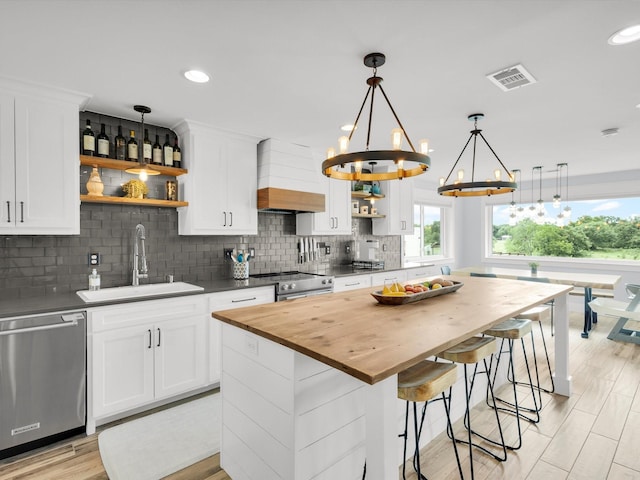 325 Beasley Rd, Combine, TX 75159 - kitchen featuring a sink, appliances with stainless steel finishes, open shelves, a chandelier, and butcher block countertops