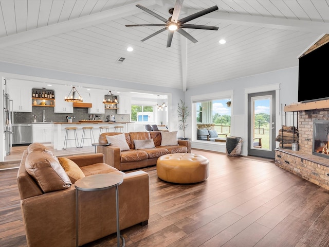 325 Beasley Rd, Combine, TX 75159 - living area with a fireplace, ceiling fan, light wood-style floors, wooden ceiling, and recessed lighting