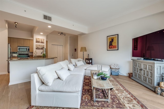 3225 Turtle Creek Blvd Unit 326, Dallas, TX 75219 - living area featuring light wood-type flooring, crown molding, and recessed lighting