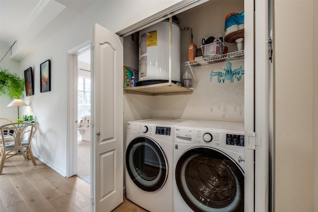 3225 Turtle Creek Blvd Unit 326, Dallas, TX 75219 - laundry room featuring light wood finished floors, independent washer and dryer, and baseboards