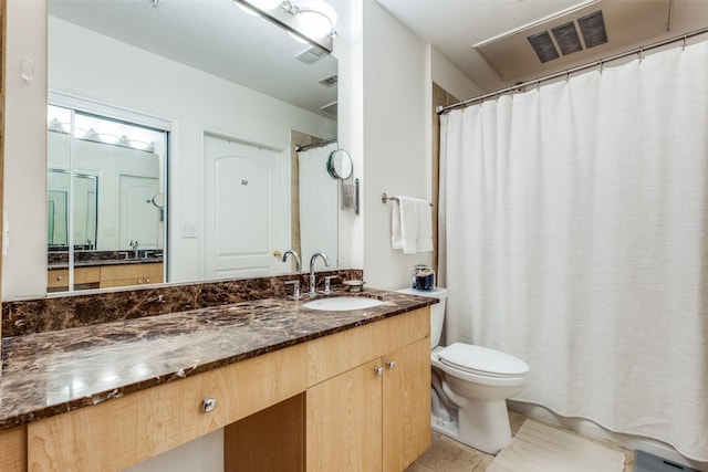 3225 Turtle Creek Blvd Unit 326, Dallas, TX 75219 - bathroom featuring toilet, vanity, tile patterned floors, and a shower with curtain
