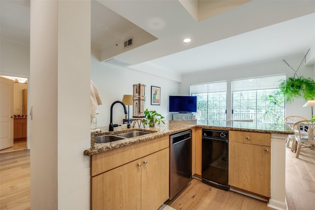 3225 Turtle Creek Blvd Unit 326, Dallas, TX 75219 - kitchen with stainless steel dishwasher, a sink, light stone counters, light wood finished floors, and light brown cabinets