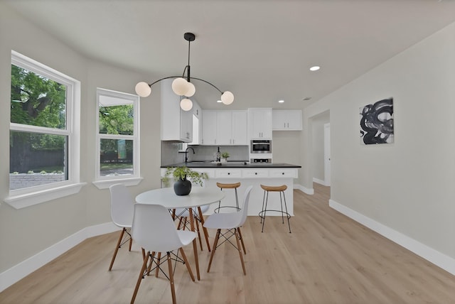1146 Norwood Dr, Hurst, TX 76053 - dining space featuring light wood-style flooring, baseboards, and recessed lighting