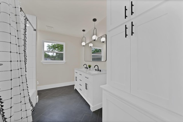 1146 Norwood Dr, Hurst, TX 76053 - bathroom featuring a shower, double vanity, and baseboards