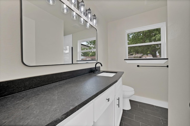 1146 Norwood Dr, Hurst, TX 76053 - bathroom with vanity, toilet, tile patterned flooring, and baseboards