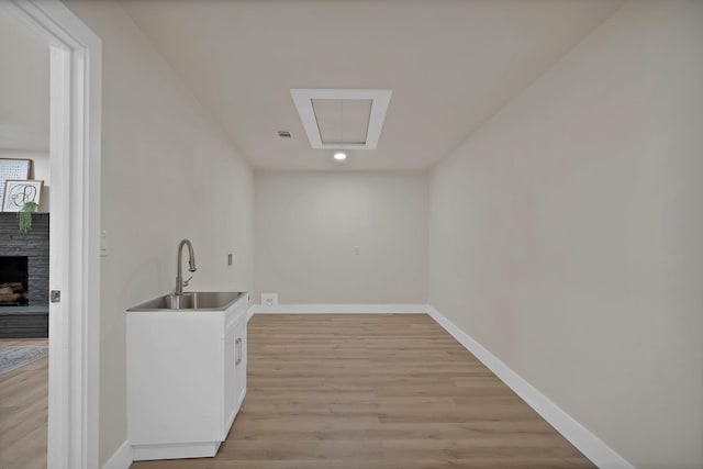 1146 Norwood Dr, Hurst, TX 76053 - bar with a sink, baseboards, light wood-type flooring, a stone fireplace, and recessed lighting
