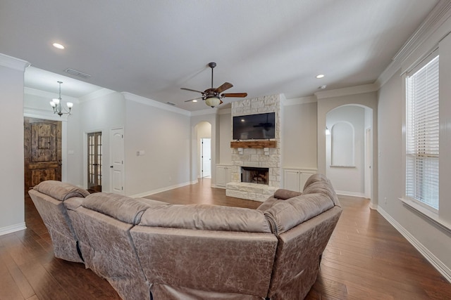 160 Melbourne Dr, Willow Park, TX 76087 - living area with arched walkways, crown molding, dark wood finished floors, a fireplace, and a ceiling fan