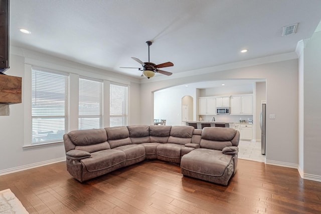 160 Melbourne Dr, Willow Park, TX 76087 - living area featuring arched walkways, a ceiling fan, baseboards, hardwood / wood-style floors, and crown molding