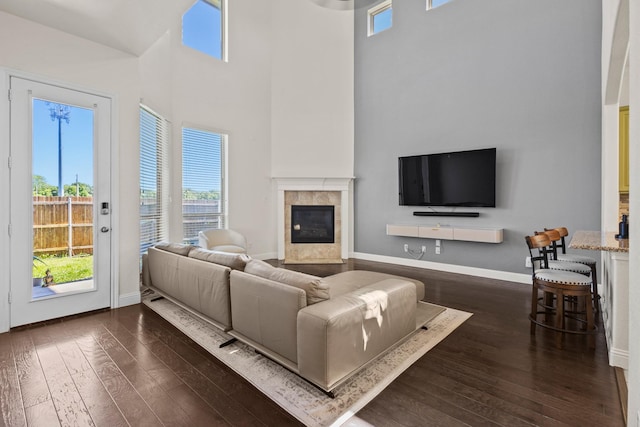 417 Burberry, Grand Prairie, TX 75052 - living room featuring a premium fireplace, a high ceiling, dark wood-style floors, and baseboards