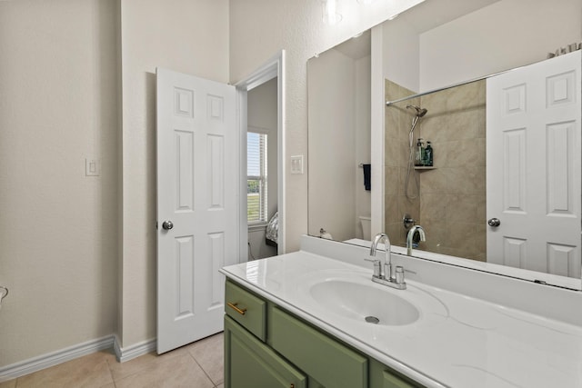 417 Burberry, Grand Prairie, TX 75052 - bathroom with toilet, tile patterned flooring, vanity, baseboards, and a tile shower