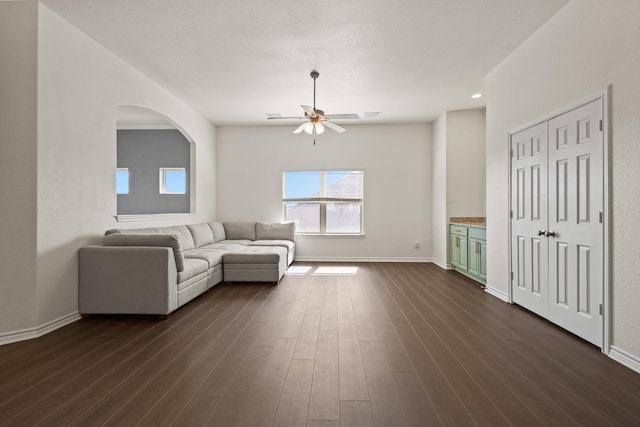 417 Burberry, Grand Prairie, TX 75052 - living area with ceiling fan, dark wood finished floors, baseboards, and arched walkways
