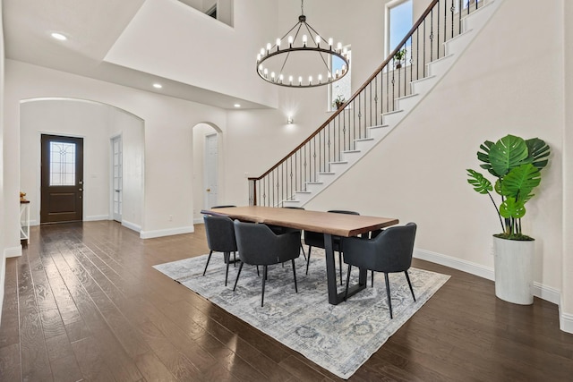 417 Burberry, Grand Prairie, TX 75052 - dining room with arched walkways, dark wood finished floors, baseboards, stairs, and a chandelier