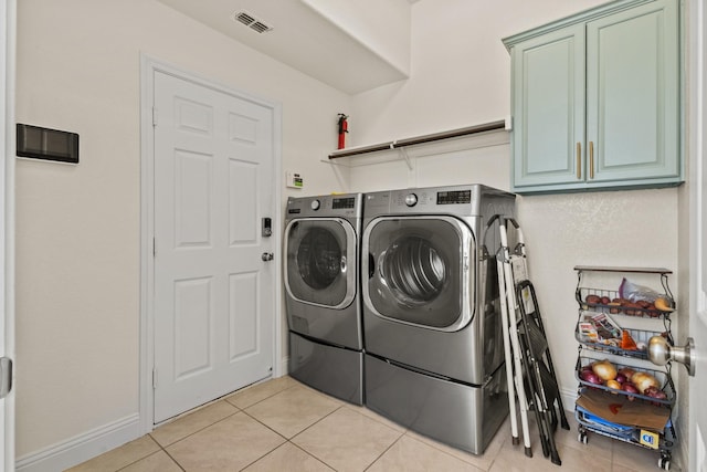 417 Burberry, Grand Prairie, TX 75052 - laundry room featuring cabinet space, washing machine and dryer, and light tile patterned floors