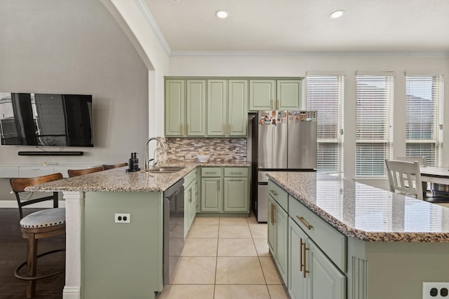 417 Burberry, Grand Prairie, TX 75052 - kitchen with green cabinets, appliances with stainless steel finishes, a sink, crown molding, and a peninsula