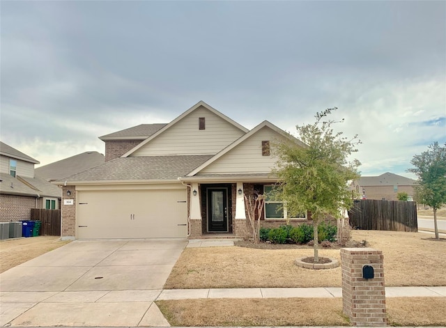 304 Eden Dr, Fate, TX 75189 - view of front facade featuring a garage, fence, driveway, roof with shingles, and brick siding