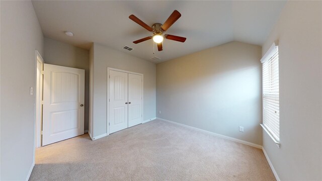 304 Eden Dr, Fate, TX 75189 - unfurnished bedroom with light carpet, baseboards, a closet, vaulted ceiling, and ceiling fan