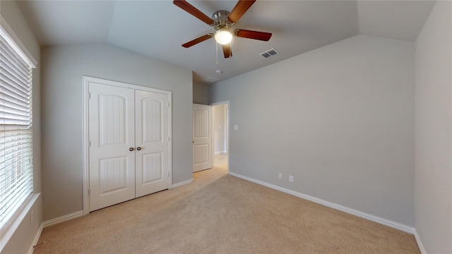 304 Eden Dr, Fate, TX 75189 - unfurnished bedroom with vaulted ceiling, light colored carpet, a closet, multiple windows, and baseboards