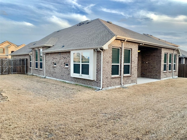 304 Eden Dr, Fate, TX 75189 - back of house with a fenced backyard, brick siding, and roof with shingles