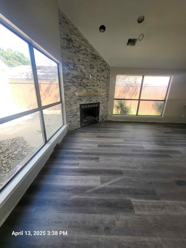 202 Sunset Dr, Glenn Heights, TX 75154 - unfurnished living room with a fireplace, healthy amount of natural light, wood finished floors, and high vaulted ceiling