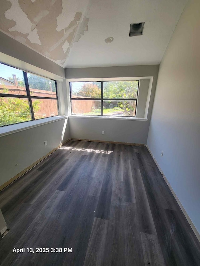 202 Sunset Dr, Glenn Heights, TX 75154 - spare room featuring plenty of natural light, wood finished floors, and baseboards